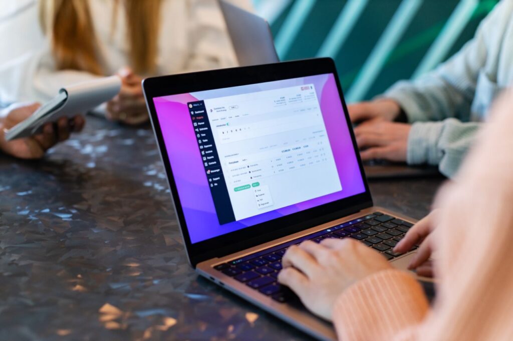Close-up of a laptop during a team meeting in New York, showcasing collaboration and technology.