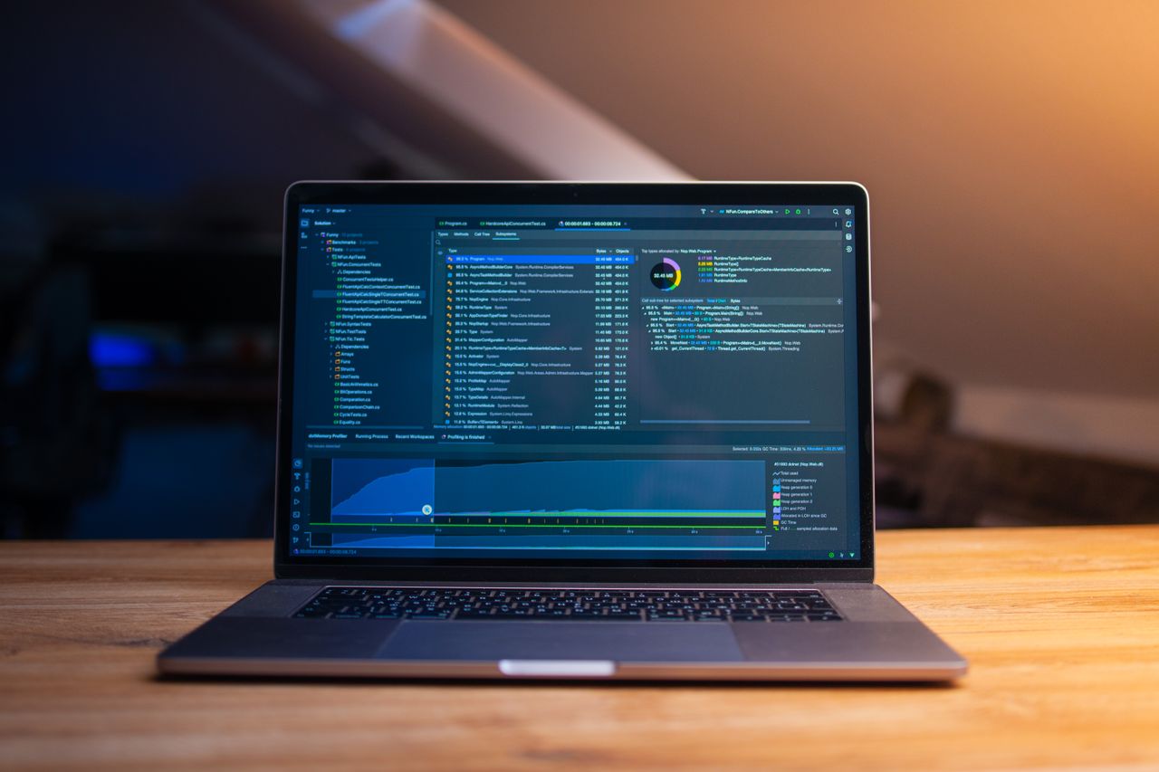 The Art of Drawing Readers In: Your attractive post title goes here A laptop displaying code on a wooden desk, in a dimly lit workspace.